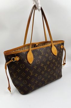 The Neverfull PM tote pairs timeless design with heritage details. Crafted from the classic LV monogram canvas with natural cowhide trim, it is capacious yet not bulky, with side laces that cinch for a sleek allure or loosen for a casual look. Slim, comfortable handles slip easily over the arm. The Louis Vuitton monogram is a print that is carefully crafted from durable, brown canvas, Louis Vuitton's embossed, classic interwoven "LV" has remained the brand's signature since 1896. Louis Vuitton’s On The Go Louis Vuitton Bag Fake, Louis Vuitton Game Day Bag, Affordable Louis Vuitton, Louis Vuitton Handbags Lxrandco, Louis Vuitton Handbags Classic Louis Vuitton Official, Louis Vuitton Monogram Neverfull, Louis Vuitton Neverfull Pm, Louis Vuitton Dust Bag, Lv Neverfull