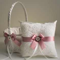 two white wedding baskets with pink bows on them