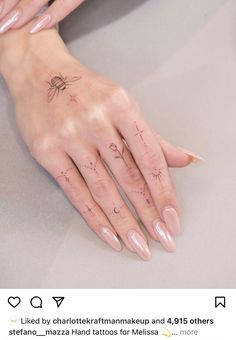 a woman's hand with tattoos on it