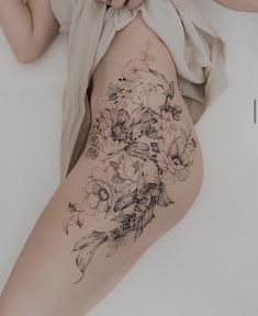 a woman's thigh with flowers on it