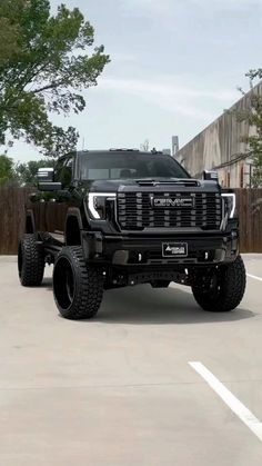 a large black truck parked in a parking lot