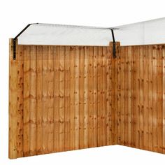 a wooden fence with a white sheet on top and bottom section closed up to the side