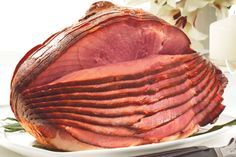 a large ham sitting on top of a white plate