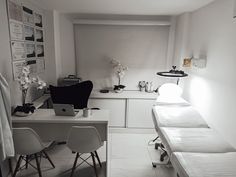 a room with two beds and a desk