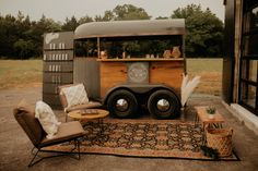 an old truck is parked on the side of the road with some furniture around it