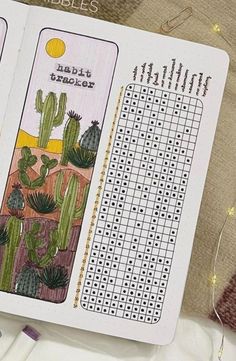 an open book with crosswords and cactuses on it next to some scissors