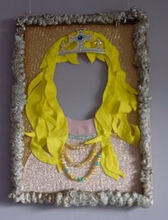 a yellow and white photo frame with a princess's crown on top of it