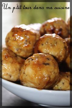 a white bowl filled with meatballs covered in sauce