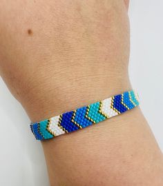 - Handmade beaded blue colors minimalist chevron bracelet - Miyuki seed beads, gold beads are 24K gold plated - The length of bracelet is 17,5 cm extended 5 cm, bracelet width 0.8 cm - The length of bracelet is 6,88 inches extended 1,96 inches, bracelet width is 0,31 inches JEWELRY CARE - Keep jewelry dry - Take it off before taking shower, bath, swimming or exercising - Makeup, perfume, hairspray apply before wearing jewelry - Store your jewelry somewhere dry, not in the bathroom Handmade in Cy Blue Beaded Minimalist Friendship Bracelets, Minimalist Handmade Blue Friendship Bracelets, Minimalist Blue Friendship Bracelets With Colorful Beads, Handmade Minimalist Blue Bracelet, Blue Chevron Bracelet, Bracelet Chevron, Chevron Bracelet, Blue Chevron, Handmade Bracelet