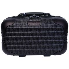 a black and white suitcase with skulls on the front, sitting against a white background