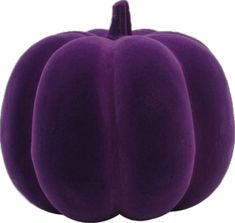 a purple pumpkin sitting on top of a white surface