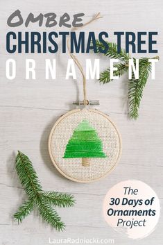 a christmas tree ornament hanging from a wooden hoop with the words ombre christmas tree ornament on it