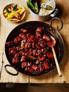 the food is prepared and ready to be eaten in the pan on the wooden table