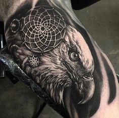 an eagle with a dream catcher tattoo on his arm and shoulder is shown in black and white