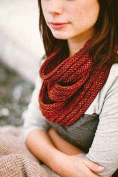 a woman wearing a red knitted scarf