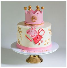 a three tiered cake with pep the pig on top