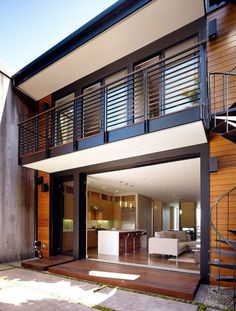 a modern house with an open floor plan and stairs leading up to the upper level