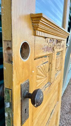 an old wooden door with metal handles and knobs