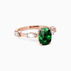 a green and white ring with diamonds on the band, set in 18k rose gold