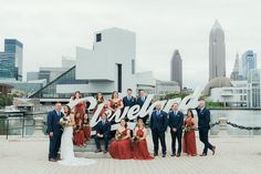 a group of people standing next to each other in front of a cityscape