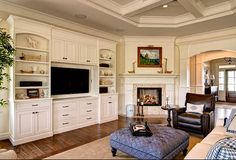 a living room filled with furniture and a flat screen tv mounted to the side of a wall