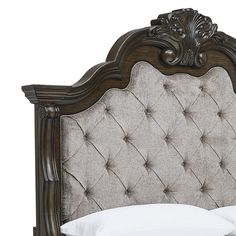 an ornate headboard with white pillows on it