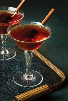 two glasses filled with liquid sitting on top of a table