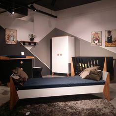 a child's bedroom with a bed, dresser and other items on display in the room