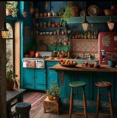 a kitchen with blue walls and wooden floors has potted plants on the counter top