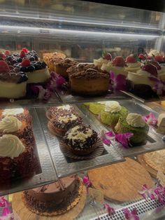 a display case filled with lots of different types of cakes