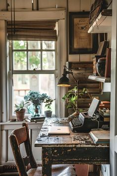 an old fashioned desk and chair in front of a window with a typewriter on it