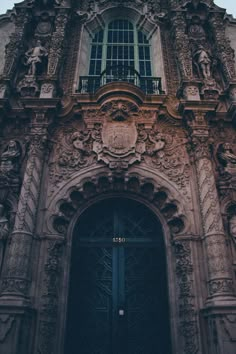 an old building with ornate carvings on the front door and windows, in gothic architecture