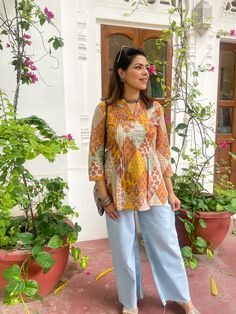 A beautiful hand block printed top perfect for spring / summer time . Jaipuri print along with the soothing Indian  cotton fabric makes it comfortable to wear and pleasing to look at it . This Kurti features 3/4the sleeves and is  hip length .  The pleating design makes for a stylish cut . Made with love by our artisans of jaipur ,India  Model is wearing size M  Size chart in pics Jaipuri Dress Design, Indian Mom Outfits, Jaipuri Kurti Designs Short, India Casual Outfit, Indian Print Tops, Festive Yellow Block Print Kurta, Yellow Printed Long-sleeve Kurta, Yellow Printed Long Sleeve Kurta, Yellow Chikankari Embroidered Festive Top