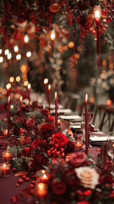 the table is set with candles, flowers and greenery for a festive dinner