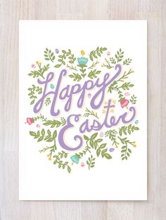 a card with the words happy easter written in purple and green leaves on top of it