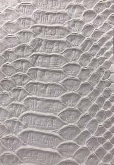 an abstract white quilt with wavy lines on it