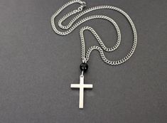 "Square edged Cross Pendant, made from Stainless Steel, linked with a Black Onyx bead, and finished with a Stainless Steel Curb Chain. C R O S S - Made from polished Stainless Steel Genuine Black Onyx Bead connected with Sterling Silver wire Total Length: 2\" long and 3/4\" wide Nice thickness and solid feel Polished on both sides C H A I N - Medium weight Stainless Steel Curb chain, links are 3mm wide Nice, Solid Feel Made from soldered steel Very fluid movement of the links Lobster clasp closu Chain With Cross, Fluid Movement, Stainless Steel Cross Pendant, Lubbock Tx, Chain Links, Onyx Bead, White Gift Boxes, Curb Chain, Link Necklace