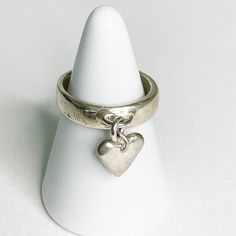 Wear you heart on your sleeve, well finger. This sterling silver ring has a tiny swinging heart charm. A unique way to wear a heart charm, this ring is the perfect way to tell someone you love them, or yourself! AvailabilitySize 7 available immediatelyOther sizes made-to-order DetailsSterling silver Heart On Your Sleeve, Charm Ring, Casting Jewelry, Funky Jewelry, Charm Rings, Fancy Jewelry, Brass Jewelry, Jewelry Inspo, Heart On