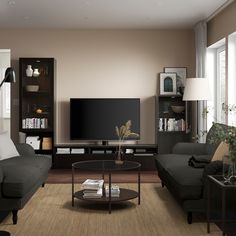 a living room filled with furniture and a flat screen tv mounted on a wall next to a window