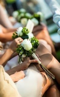 the brides are sitting down with their bouquets on their lapel covers,