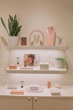 there are many items on the shelves in this room, including plants and jewelry boxes