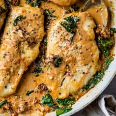 chicken with spinach and gravy in a skillet