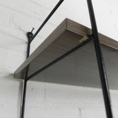 the shelf is made out of wood and metal