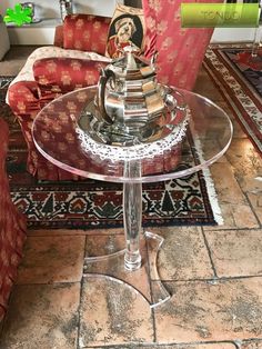 a glass table sitting on top of a tiled floor