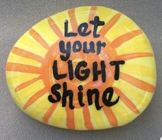 a painted rock with the words let your light shine on it