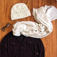 a hat, sweater and glasses are laid out on the floor