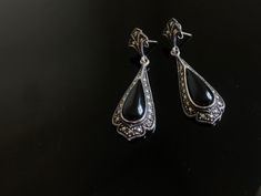 A lovely pair of Art Deco silver earrings, c1920.   Each antique earring has been adorned with ample sparky marcasites on a bed of solid silver, centred with an oval onyx. Beautifully sparkly Art Deco earrings.  So very elegant. Would make a lovely gift for her or bridal earrings. All stones intact. In lovely vintage condition.  Measurements: approximately 4cm Gift wrap: Free gift wrap with this item  Please see below link for gift wrapping service; https://www.etsy.com/uk/listing/822273297/ Mat Art Deco Hallmarked Drop Earrings, Art Deco Formal Earrings Hallmarked, Hallmarked Art Deco Earrings For Anniversary, Antique Evening Earrings For Pierced Ears, Victorian Pierced Earrings For Evening, Victorian Earrings For Evening Occasions, Art Deco Sterling Silver Earrings For Formal Occasions, Vintage Hallmarked Earrings For Evening, Antique Sterling Silver Dangle Earrings