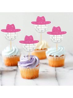 cupcakes with pink and white frosting in the shape of hats on top