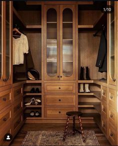 a walk in closet filled with lots of wooden furniture and shoes on top of it