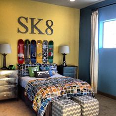 a bed room with a neatly made bed and lots of skateboards on the wall